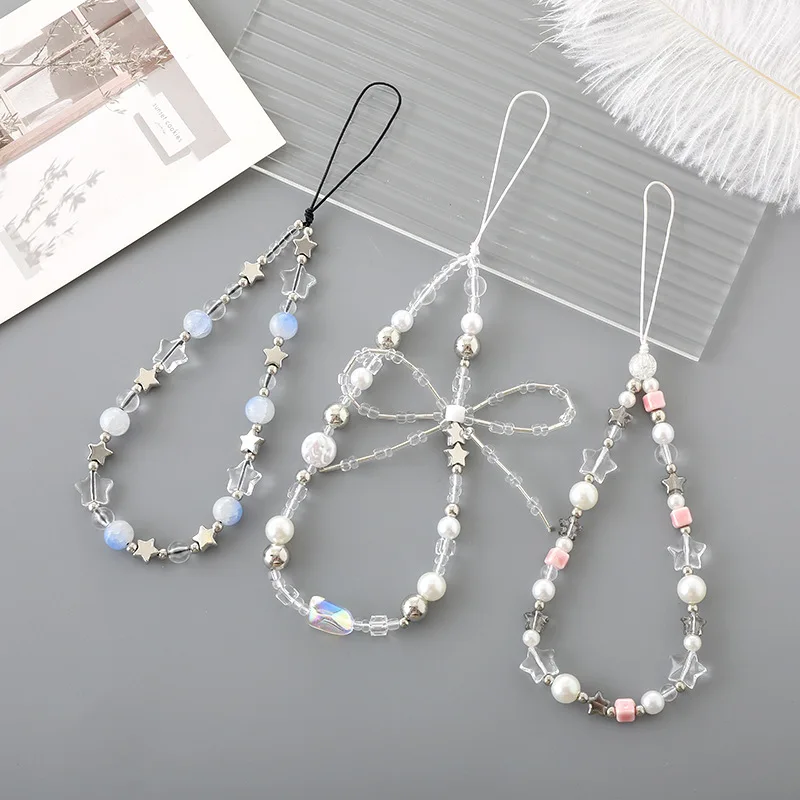 Women Accessories Picture - เคสโทรศัพท์กันลื่นรูปดาวห้าแฉก พร้อมสายคล้องมือประดับมุก โบว์ และลูกปัด ดีไซน์แฟชั่นสำหรับผู้หญิง
